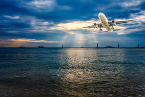 Airplane Flying Over Tropical Sea At Beautiful Sunset Or Sunrise Scenery Background Stock Photo - Download Image Now - iStock