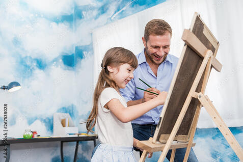 Portrait of caucasian father teaching his daughter little girl to paint and draw picture art class. Home school learn from teacher, education activities family love single dad father's day concept. Stock Photo |