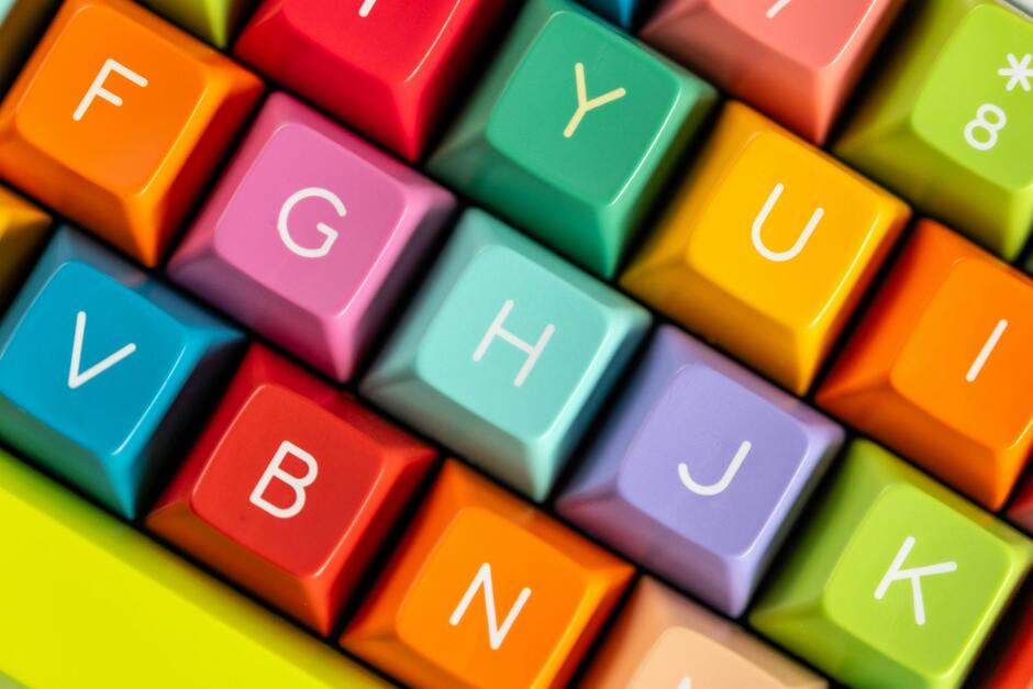 A close up of a colorful keyboard with letters on it