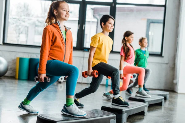 Preteen Kids Training With Dumbbells And Step Free Stock Photo and Image 242601238